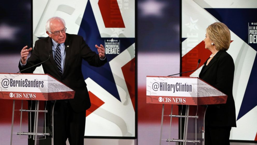 Bernie Sanders, left, makes a point as Hillary Rodham Clinton listens during a Democratic presidential primary debate, Nov. 14, 2015, in Des Moines, Iowa. 
