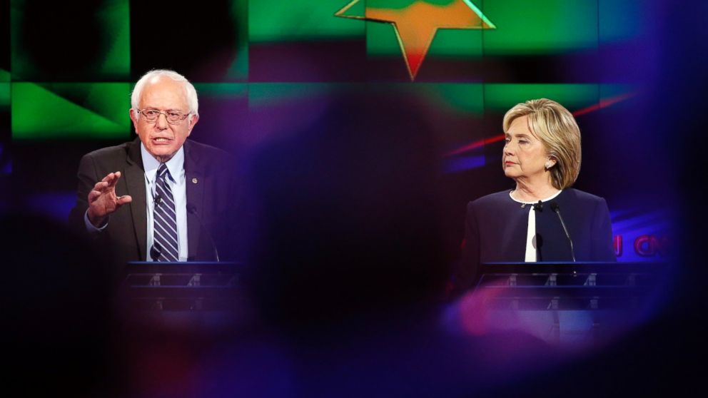 Hillary Rodham Clinton, right, looks on as Sen. Bernie Sanders, of Vermont, speaks during the CNN Democratic presidential debate, Oct. 13, 2015, in Las Vegas.