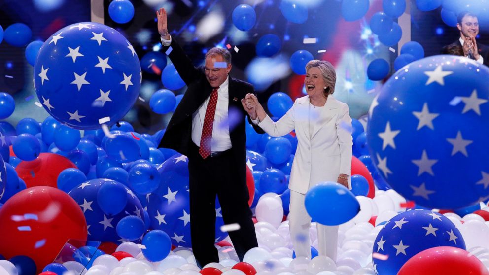 Democratic presidential nominee Hillary Clinton and Democratic vice presidential nominee Sen. Tim Kaine, walk through the falling balloons during the final day of the Democratic National Convention in Philadelphia, July 28, 2016.