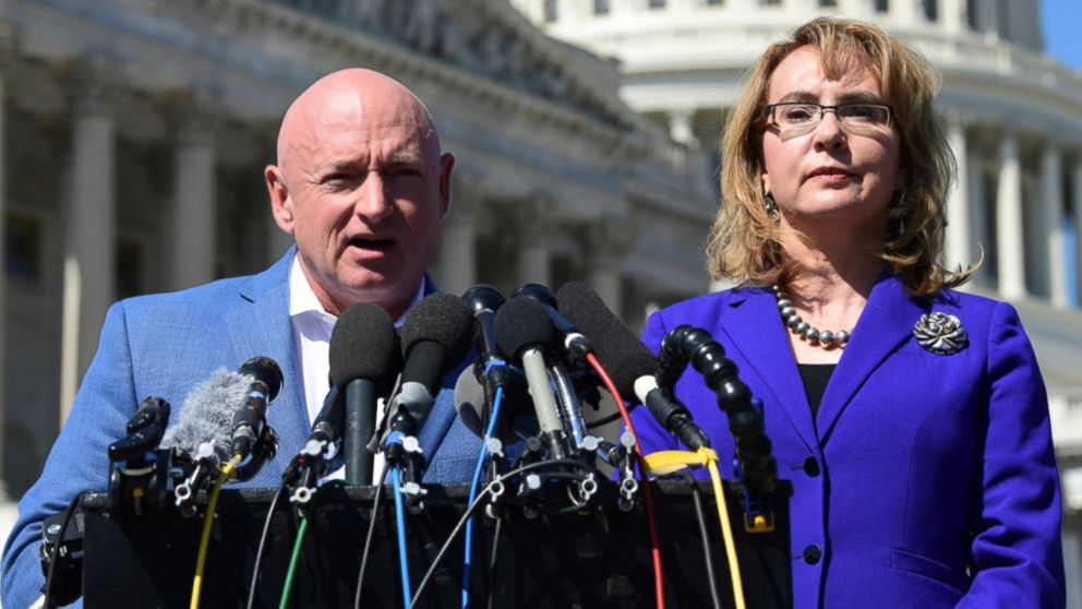 Former Rep. Gabrielle Giffords, D-Ariz., right, listens as her husband Mark Kelly, left, speaks on Capitol Hill in Washington, Oct. 2, 2017, about the mass shooting in Las Vegas. 