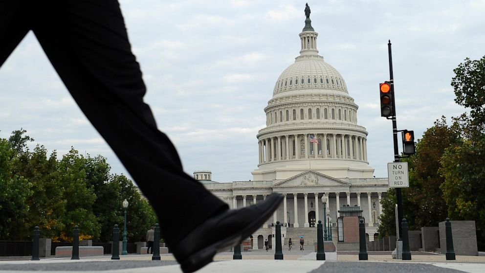 People walk near Capitol Hill in Washington, Oct. 1, 2013 where Congress plunged the nation into a partial government shutdown.