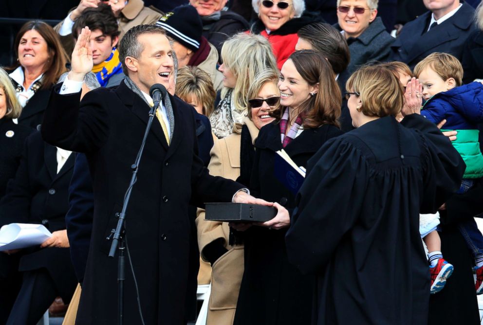 PHOTO: Missouri Gov. Eric Greitens takes the oath of office during a ceremony on the steps of the capitol in Jefferson City, Mo., Monday, Jan. 9, 2017.  Looking on is his wife, Sheena. 