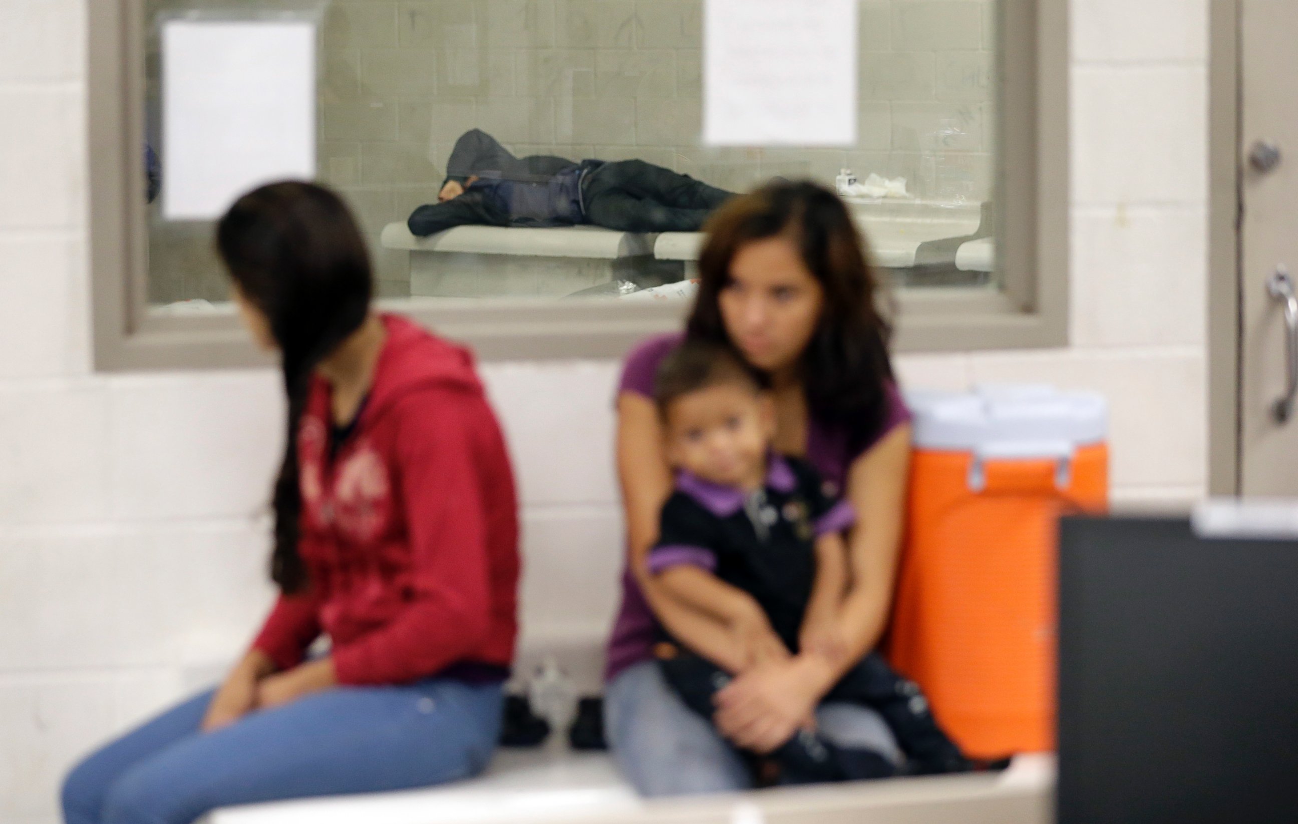 Detainees wait at a U.S. Customs and Border Protection processing facility, June 18, 2014, in Brownsville, Texas.