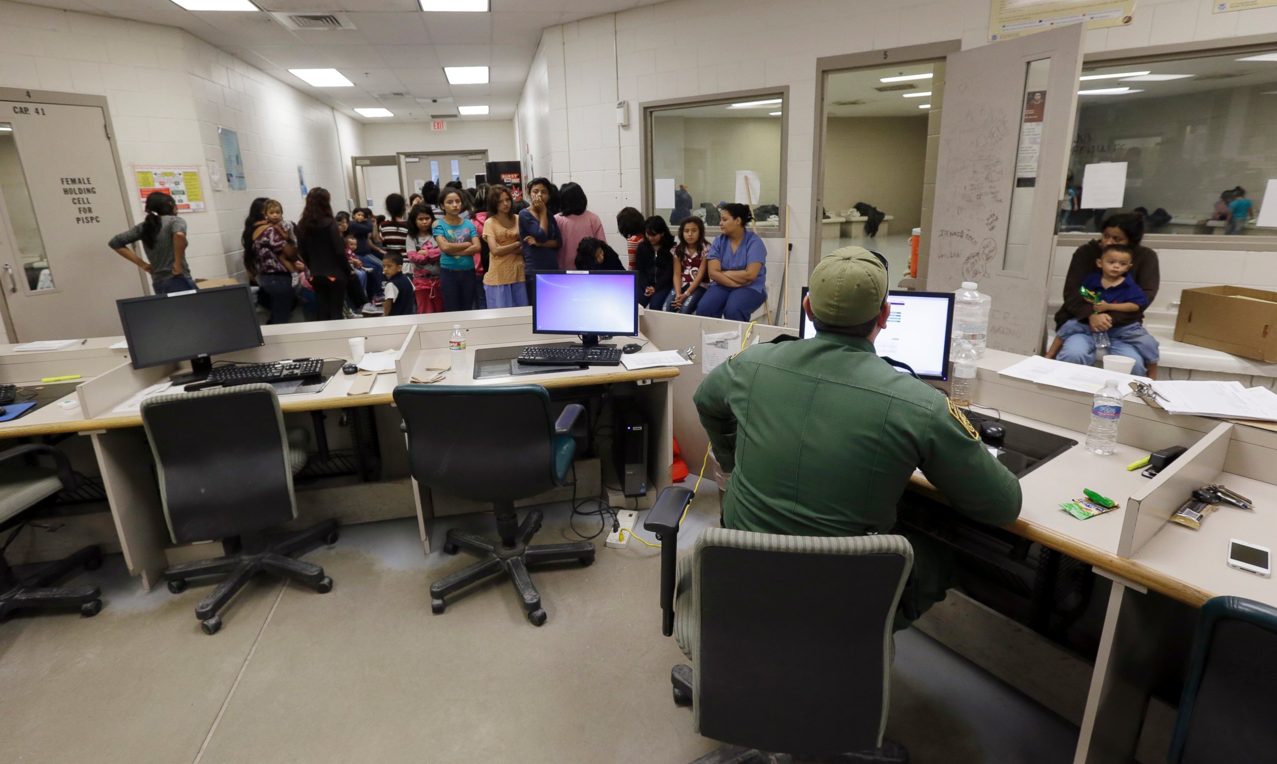 U.S. Customs and Border Protection agents work at a processing facility, June 18, 2014, in Brownsville, Texas.