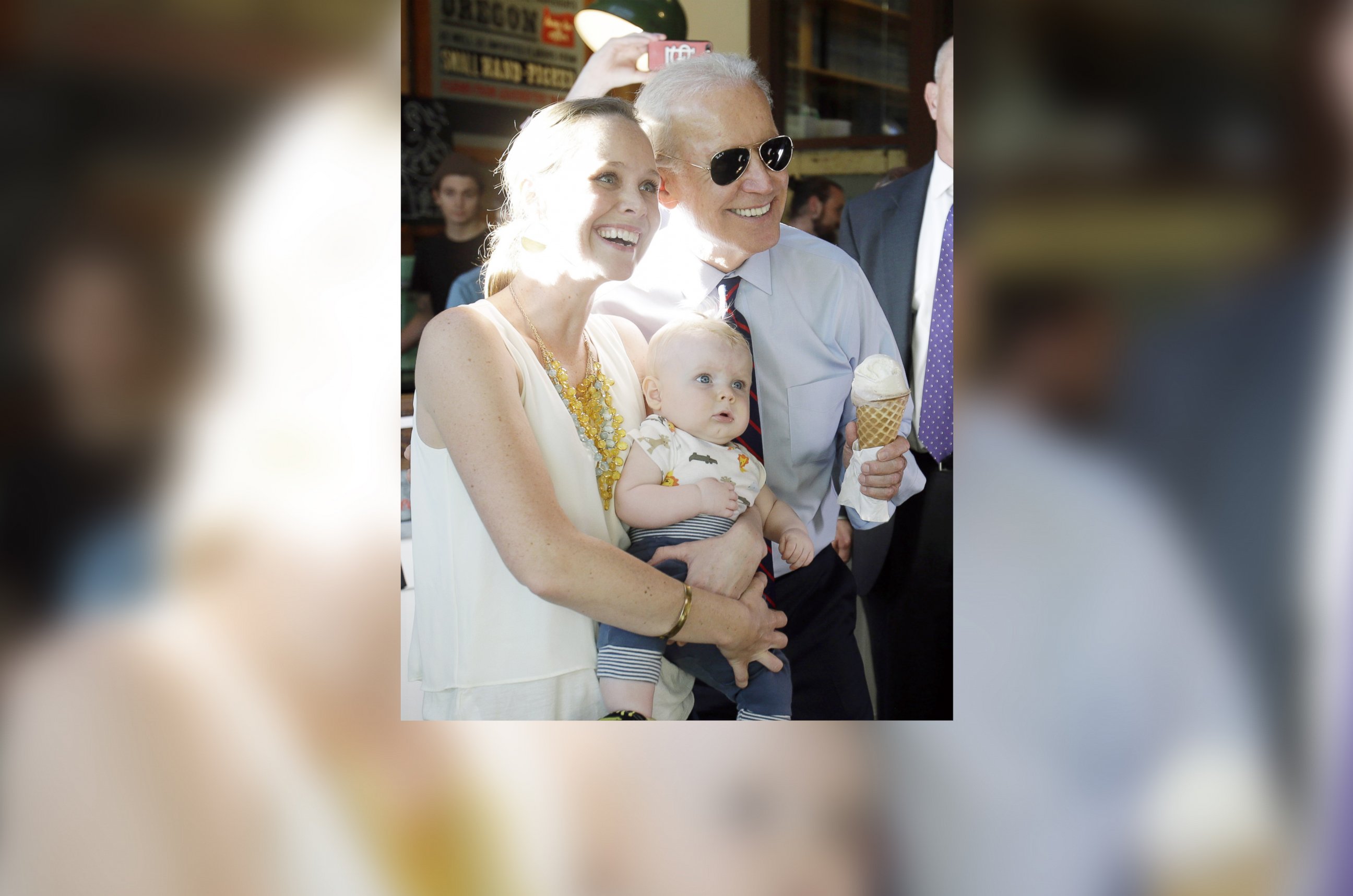 PHOTO: Vice President Joe Biden holds an ice cream cone as he poses for a photo with Hope Lobkowizc and her son, Owen, at an ice cream parlor after a campaign rally in Portland, Ore., Oct. 8, 2014.