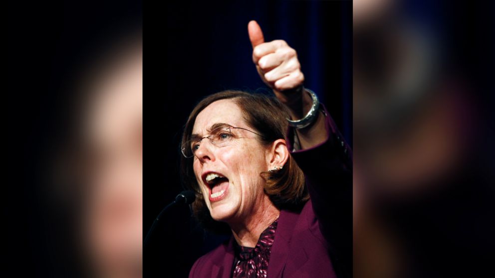 In this Nov. 6, 2012 file photo, Oregon Democratic Secretary of State Kate Brown celebrates at the podium after winning her race at Democratic headquarters in Portland, Ore.