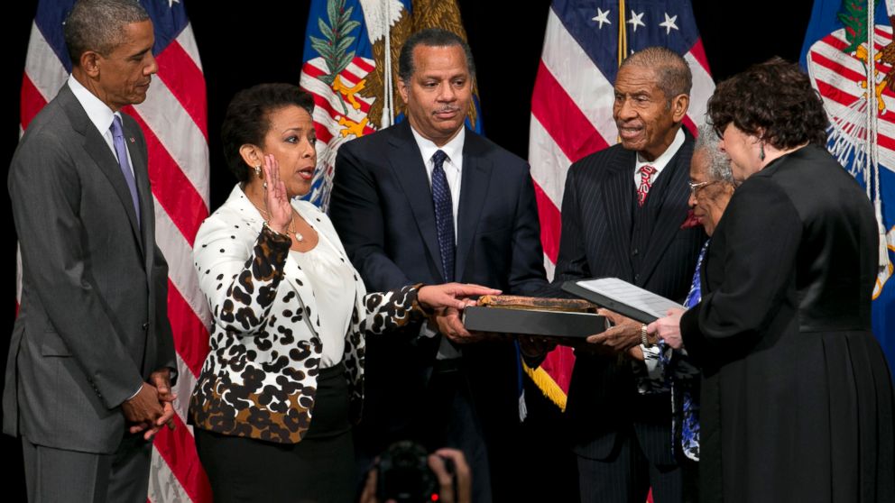 Attorney General Loretta Lynch, second from left, next to President Barack Obama, participates in a formal investiture ceremony, June 17, 2015, at the Warner Theatre in Washington. 