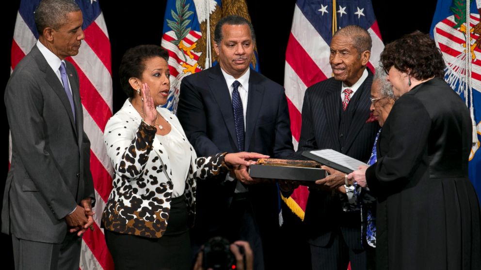Attorney General Loretta Lynch, second from left, next to President Barack Obama, participates in a formal investiture ceremony, June 17, 2015, at the Warner Theatre in Washington.