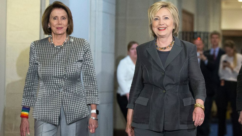 Democratic presidential candidate Hillary Clinton walks with House Minority Leader Nancy Pelosi of Calif. as they arrive for a meeting with the House Democratic Caucus, June 22, 2016, on Capitol Hill in Washington.