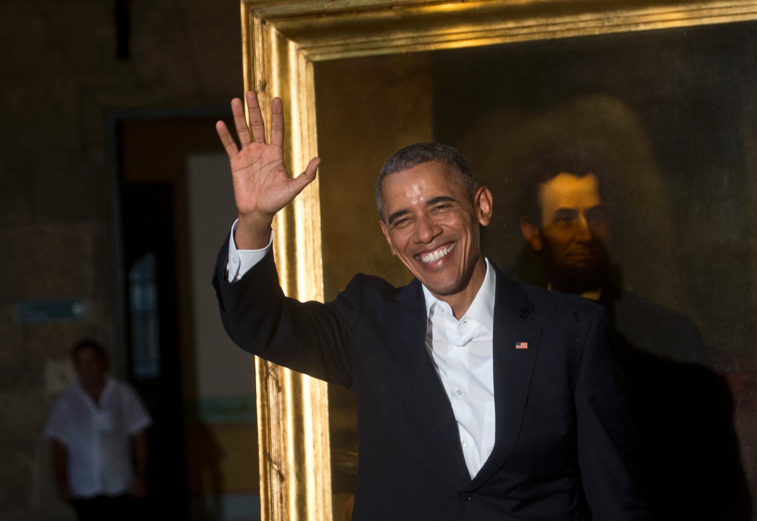 PHOTO: President Barack Obama waves to journalists next to a painting of President Abraham Lincoln at Havana's City Museum during a visit to Old Havana, Cuba, Sunday, March 20, 2016.