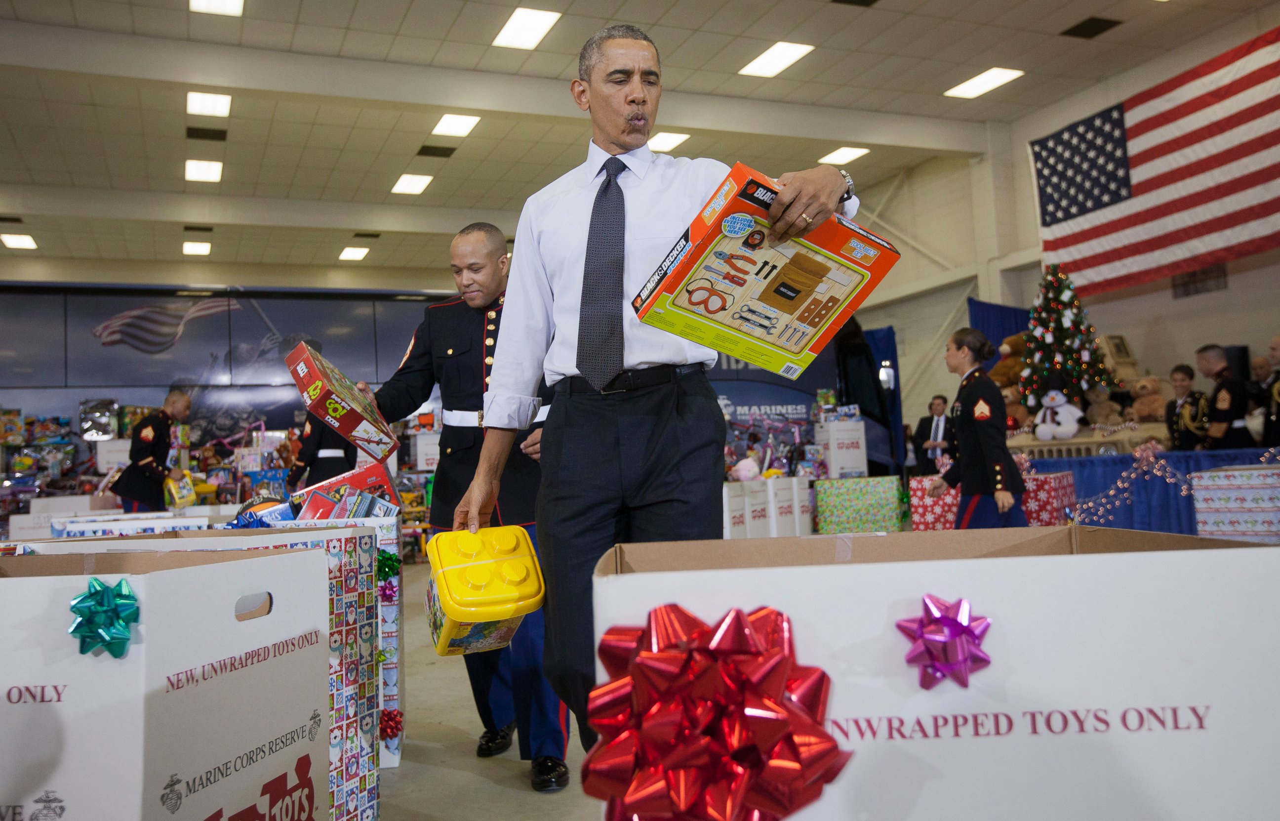 PHOTO: President Barack Obama whistles holiday songs as he helps sort toys and gifts for the Marine Corps' Toys for Tots Campaign, Wednesday, Dec. 10, 2014, at Joint Base Anacostia-Bolling in Washington. 