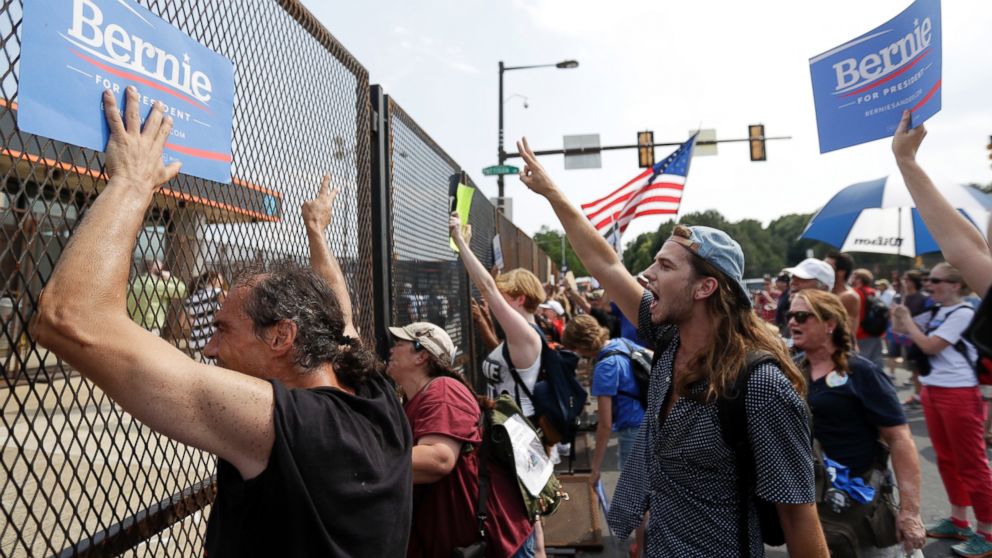 Supporters of Sen. Bernie Sanders, I-Vt., show signs to convention goers during a protest, Monday, July 25, 2016, in Philadelphia, during the first day of the Democratic National Convention.