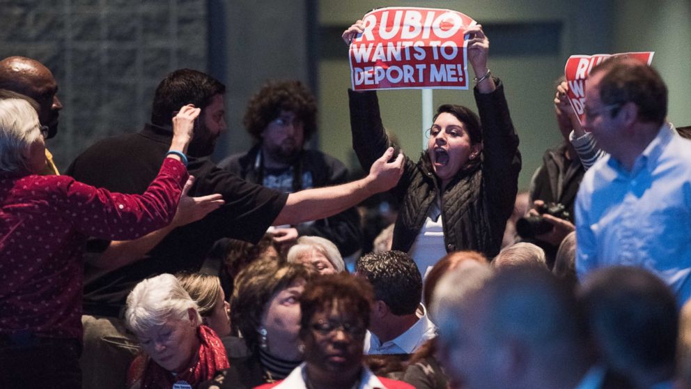 A protester disrupts presidential candidate, Sen. Marco Rubio at an economic forum, Saturday, Jan. 9, 2016, in Columbia, S.C.   Rubio was interrupted multiple times by protesters angry about his immigration policy.