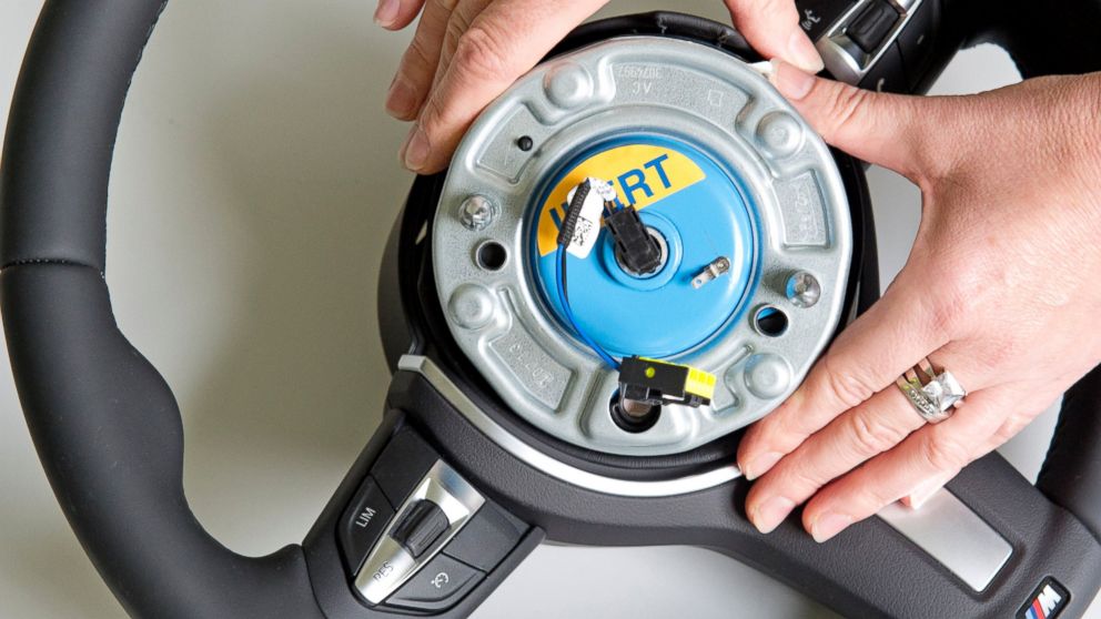 A worker demonstrates a wheel airbag initiator during a presentation for journalists at Takata Ignition Systems GmbH in Schoenebeck, Germany on April 17, 2014.