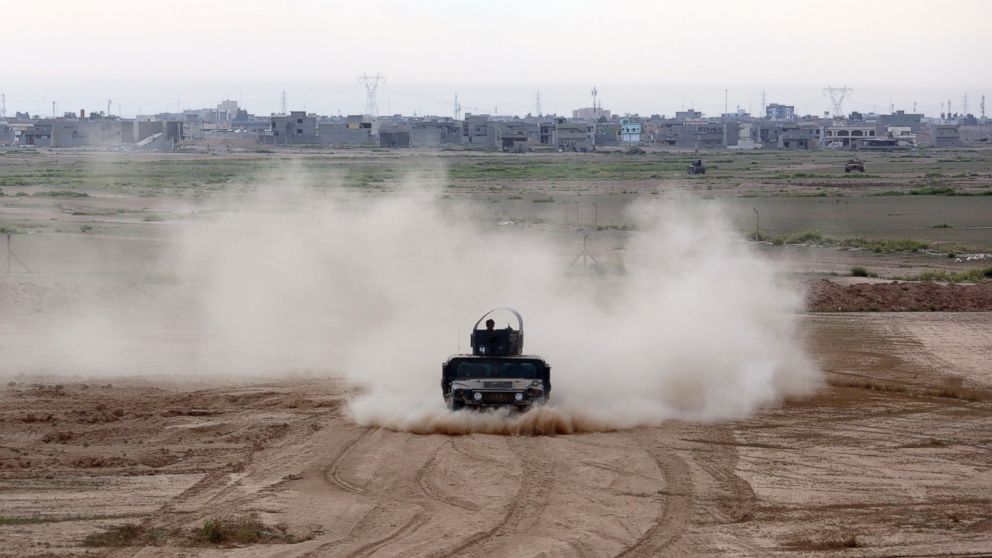 Iraqi Army armored vehicles prepare to attack Islamic State extremists in Tikrit, north of Baghdad, Iraq, March 12, 2015.