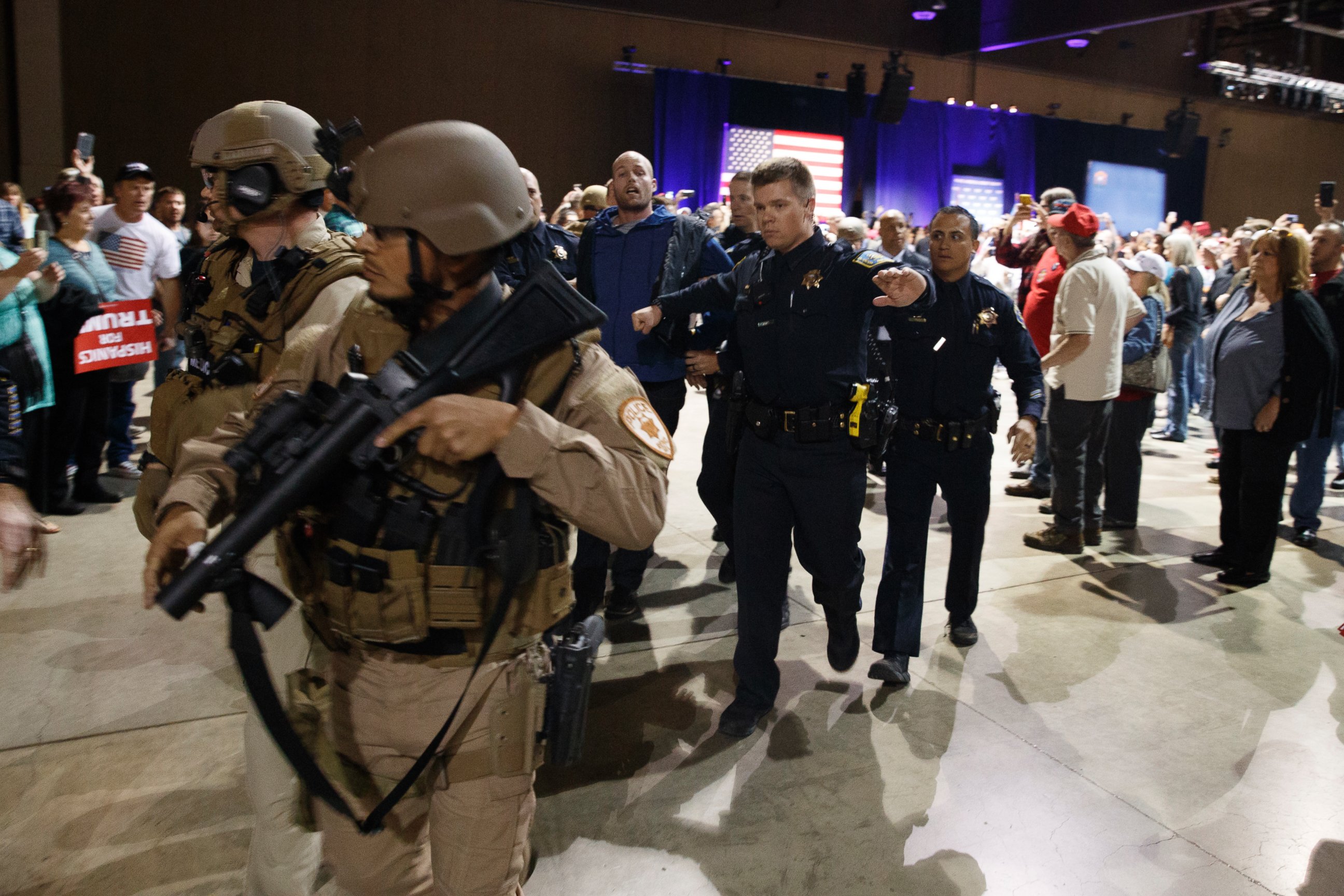 PHOTO: A man, at center with blue sweater, is escorted by law enforcement officers moments after Republican presidential candidate Donald Trump was rushed offstage by Secret Service agents during a campaign rally in Reno, Nev., on Saturday, Nov. 5, 2016.