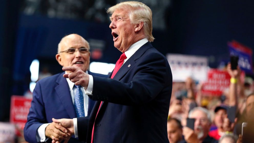 Republican presidential candidate Donald Trump arrives to speak at a campaign rally in Akron, Ohio, Aug. 22, 2016. Behind is former New York Mayor Rudy Giuliani.