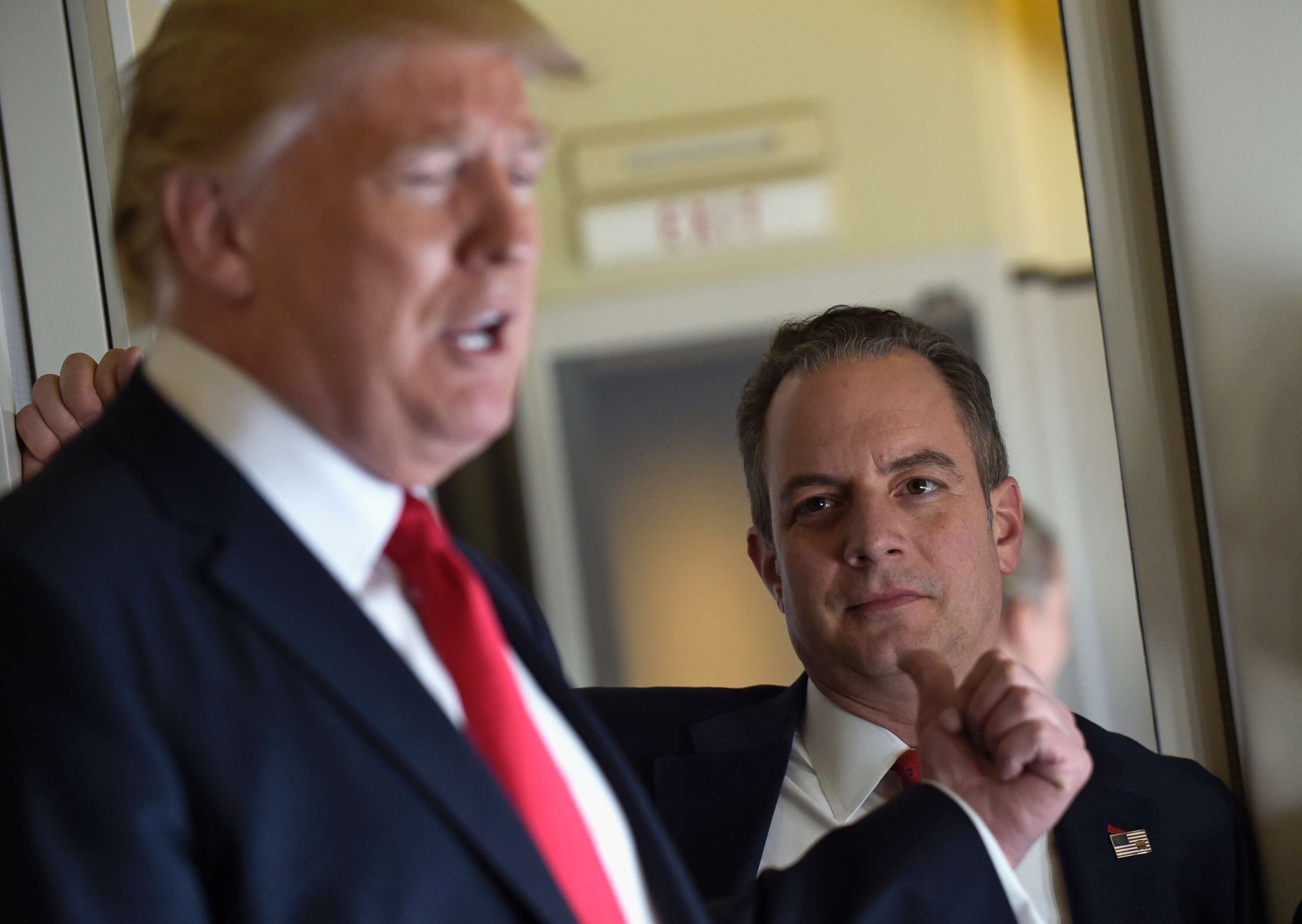 PHOTO: Then-White House Chief of Staff Reince Priebus listens at right as President Donald Trump speaks to reporters on Air Force One while traveling to Palm Beach International Airport in West Palm Beach, Fla., Friday, Feb. 3, 2017.