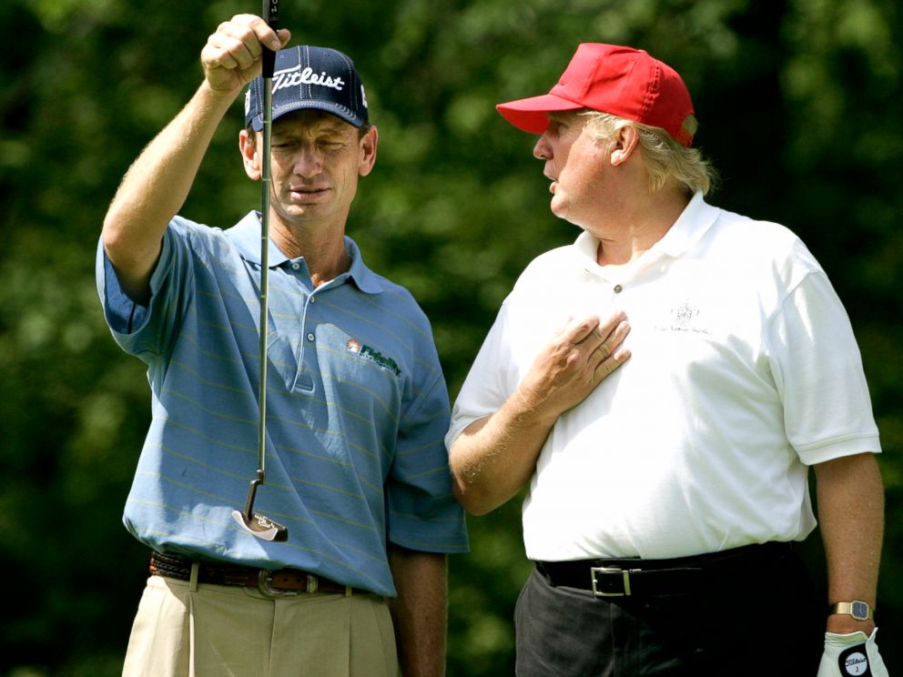 PHOTO: Brad Faxon, left, lines up a putt while listening to Donald Trump, right, on the fifth green during a Pro-Am round at the Deutsche Bank Championship golf tournament at the TPC of Boston in Norton, Mass., Thursday Aug. 31, 2006.