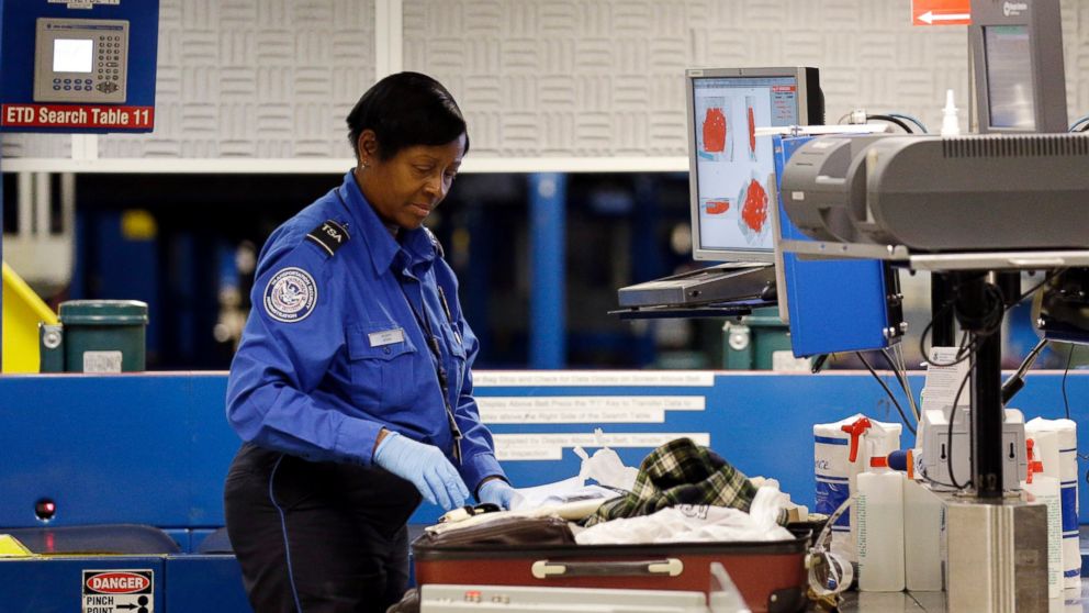 A TSA employee checks a bag at an operation area at Midway International Airport, November 21, 2014, in Chicago.