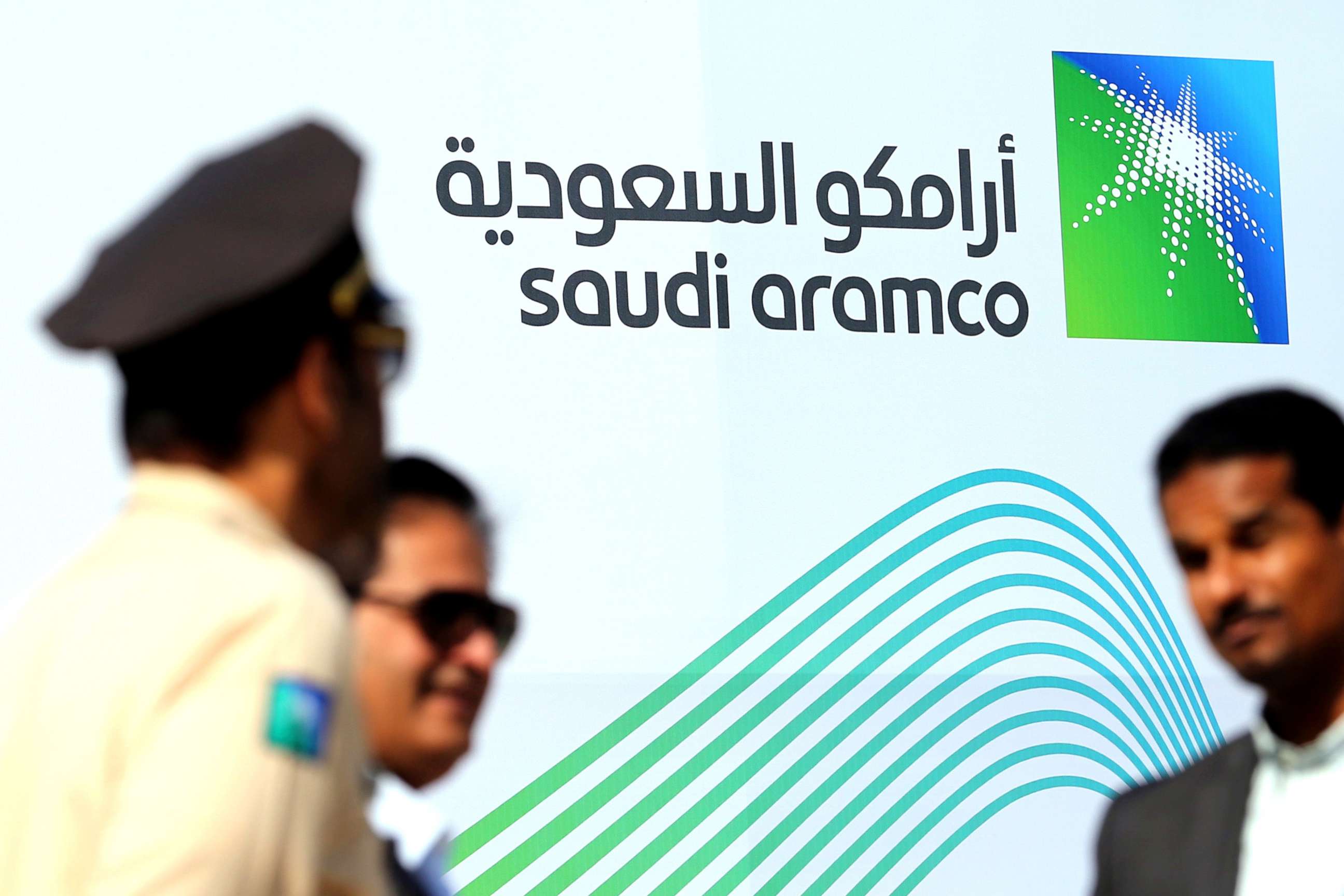 PHOTO: The logo of Aramco is seen as security personnel stand before the start of a press conference by Aramco at the Plaza Conference Center in Dhahran, Saudi Arabia, Nov. 3, 2019. 