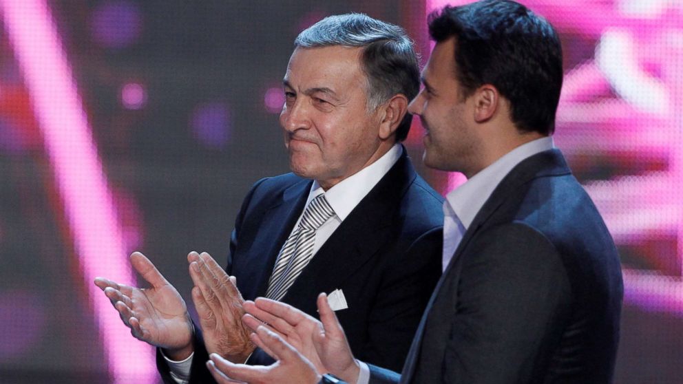 Russian real estate developer Aras Agalarov and his son, singer Emin Agalarov applaud following a press conference after the 2013 Miss USA pageant at the Planet Hollywood Resort & Casino in Las Vegas, June 16, 2013.
