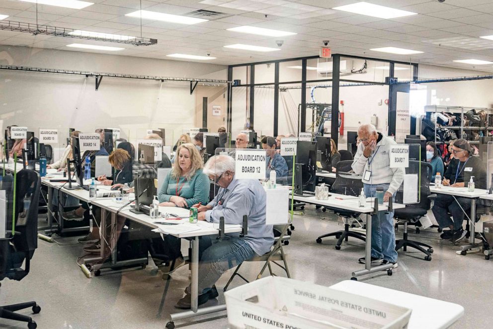 PHOTO: Election workers handle ballots for the US midterm election, in the presence of observers from both Democrat and Republican parties, at the Maricopa County Tabulation and Elections Center (MCTEC) in Phoenix, Ariz., on Nov. 9, 2022.