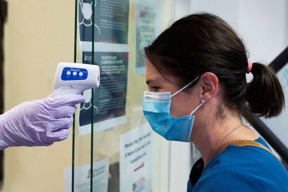 PHOTO: Jillian Golder, an employee of Oro Valley Hospital, has her temperature checked before receiving an antibody test for COVID-19 at the University of Arizona in Tucson, Ariz., July 10, 2020.