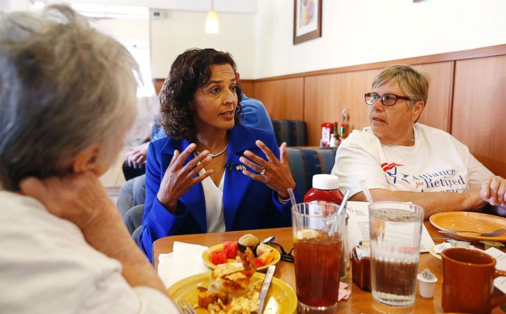 PHOTO: In this April 10, 2018, photo, Democratic candidate for the Arizona 8th Congressional District special election Dr. Hiral Tipirneni, center, talks with supporters at a local restaurant in Sun City, Ariz.