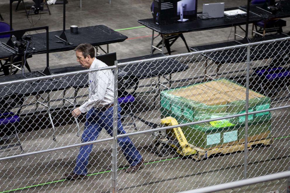 PHOTO: Senate Liaison for the Maricopa County election audit Ken Bennett returns ballots from the 2020 general election to the Veterans Memorial Coliseum to be examined and recounted by contractors hired by the Arizona senate in Phoenix on May 23, 2021.