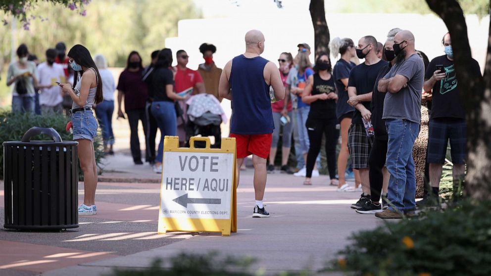 PHOTO: Voters wait in line at the Surprise Court House polling location on Nov. 03, 2020, in Surprise, Ariz.