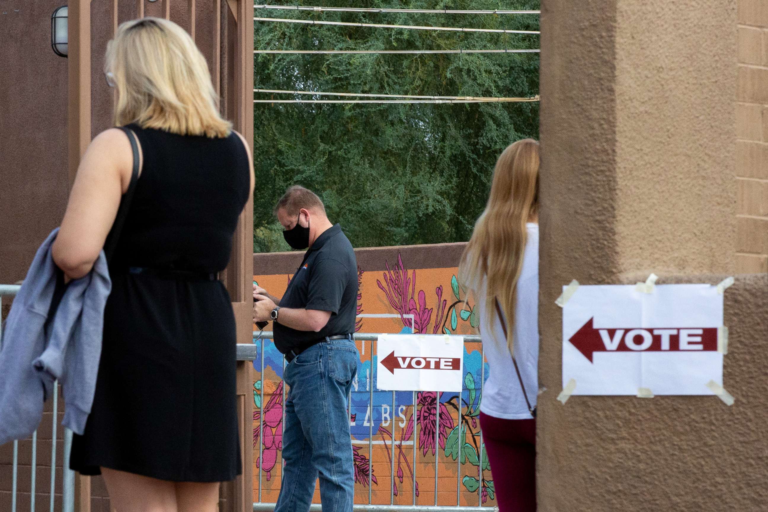 PHOTO: Voters wait to cast their ballots at Marquee Theatre on Nov. 3, 2020, in Tempe, Ariz.