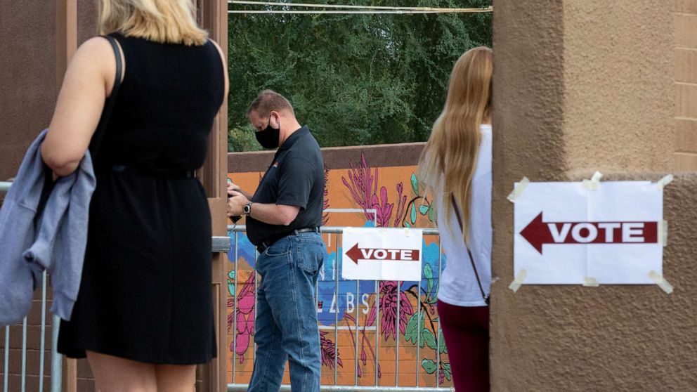 PHOTO: Voters wait to cast their ballots at Marquee Theatre on Nov. 3, 2020, in Tempe, Ariz.