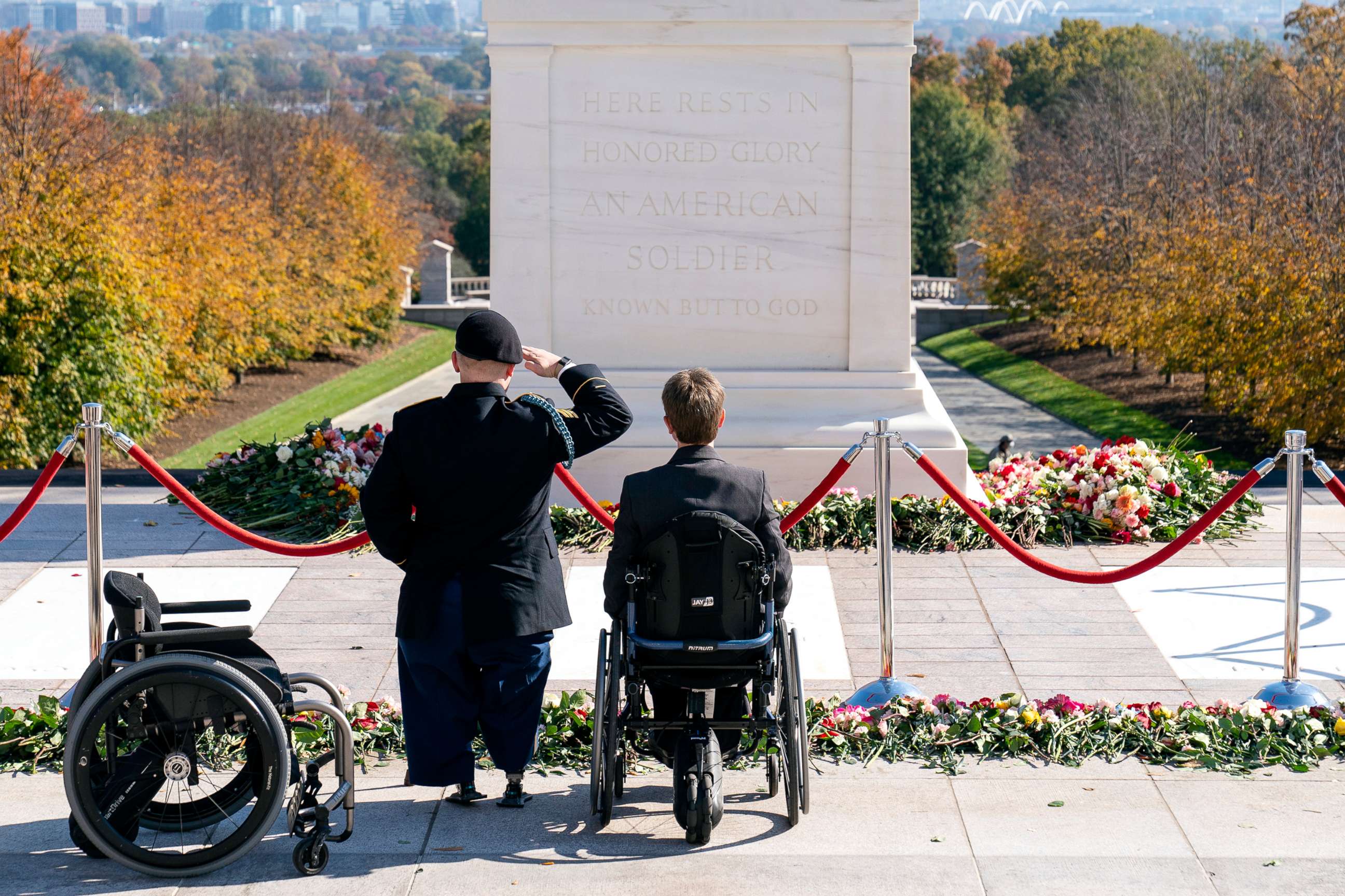 PHOTO: U.S. Army Sgt. Brian Pomerville, left, stands and salutes with his wife Tiffany Lee, after placing flowers during a centennial commemoration event at the Tomb of the Unknown Soldier, in Arlington National Cemetery, Nov. 10, 2021, in Arlington, Va.