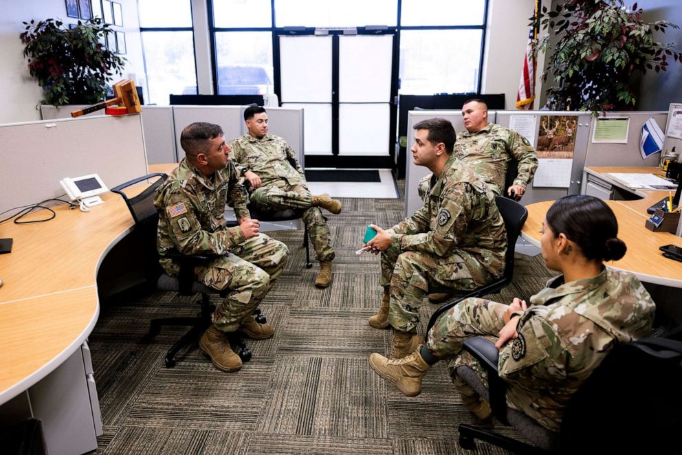 PHOTO: U.S. Army Sgt. First Class James Pulliam, left, commander of the recruiting station in Fountain, Colo.,, meets with recruiters on July 6, 2022.
