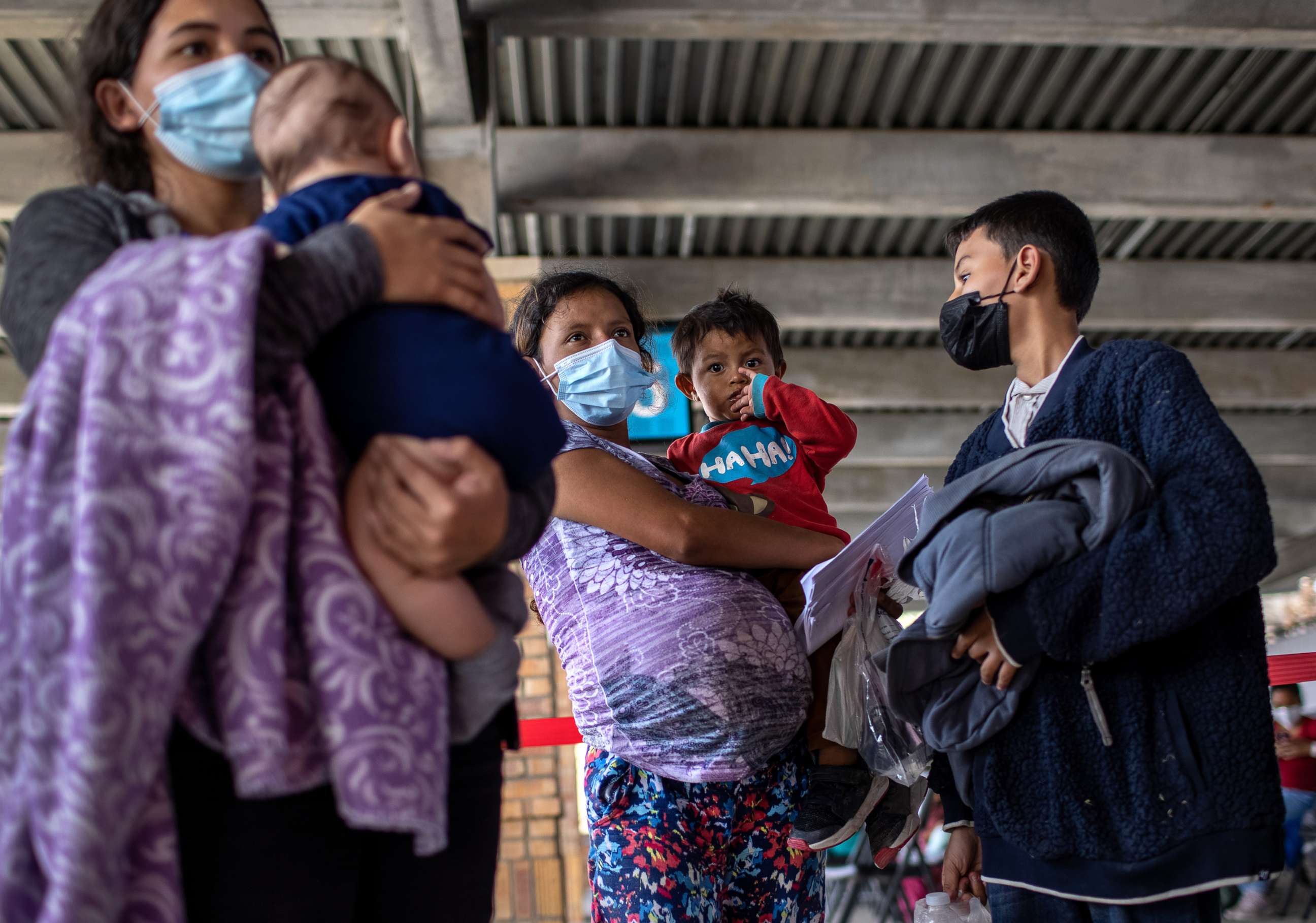 PHOTO: Central American asylum seekers arrive to a bus station after being released by U.S. Border Patrol agents, Feb. 26, 2021, in Brownsville, Texas. 