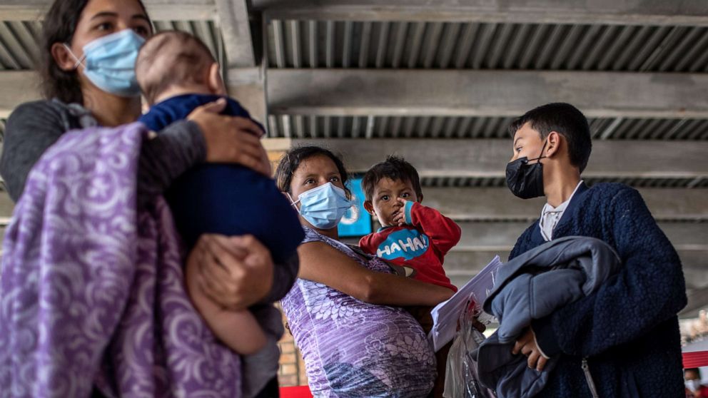 PHOTO: Central American asylum seekers arrive to a bus station after being released by U.S. Border Patrol agents, Feb. 26, 2021, in Brownsville, Texas. 