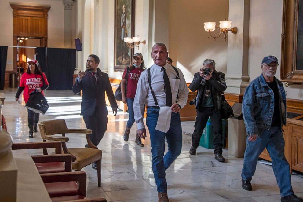 PHOTO: Chester Doles, center, leader of American Patriots USA, roams the third floor of the Georgia State Capitol building looking for the office of Georgia Secretary of State Brad Raffensperger, Jan. 6, 2021, in Atlanta.