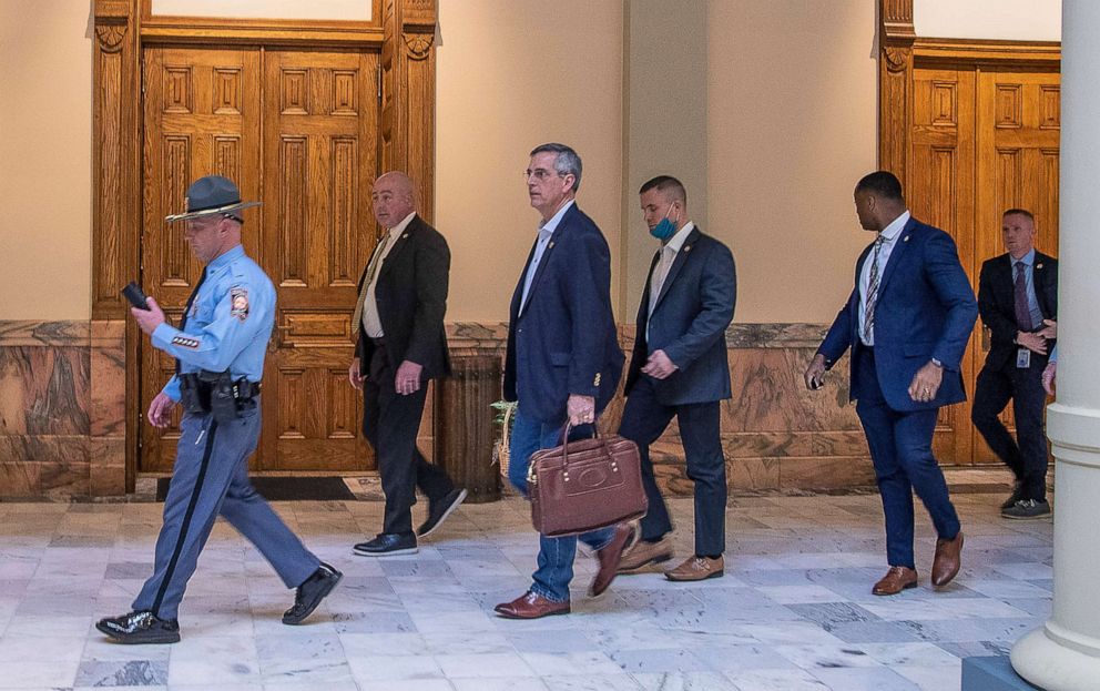 PHOTO: Lead by a Georgia State Trooper, Georgia Secretary of State Brad Raffensperger, center, exits the Georgia State Capitol building after hearing reports of threats, Jan. 6, 2021, in Atlanta.