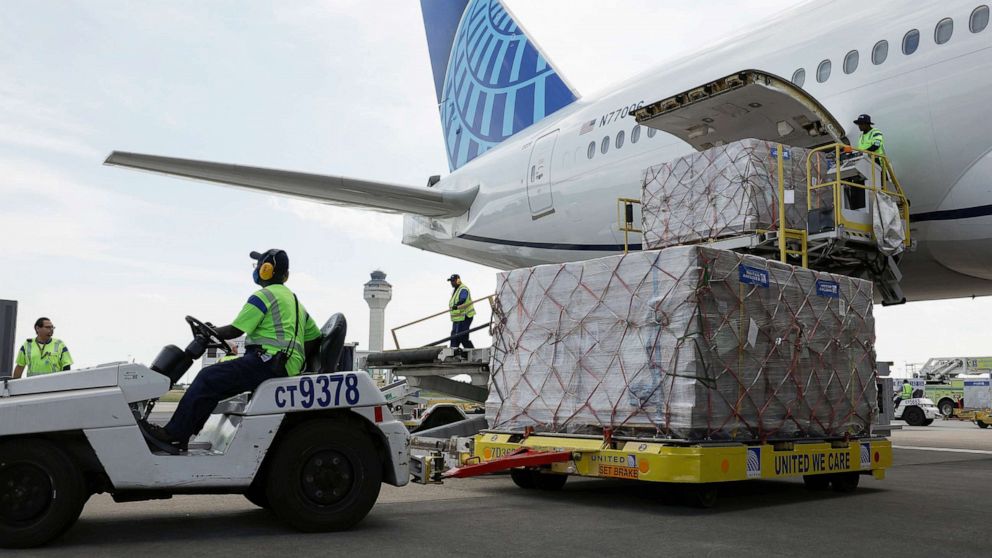 PHOTO: Cargo carrying pallets of baby formula are removed from a United Airlines passenger plane arriving from London Heathrow Airport at the Dulles International Airport, on June 17, 2022, in Dulles, Va.