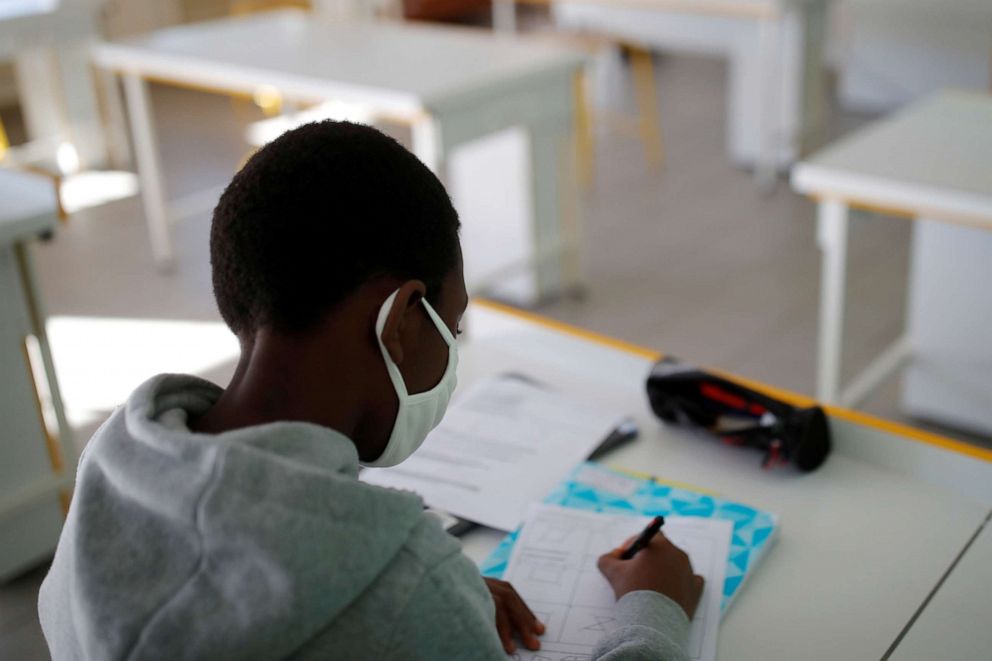 PHOTO: A student, wearing a protective face mask, works in a classroom in Nantes, France, May 20, 2020.