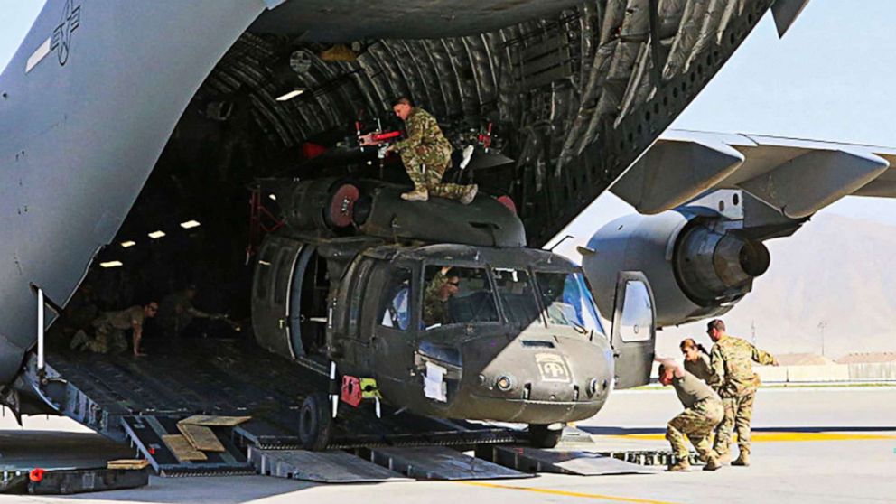 PHOTO: Aerial porters work with maintainers to load a UH-60L Blackhawk helicopter into a C-17 airplane in support of the withdrawl of U.S. troops from Bagram Air Base in Afghanistan, June 16, 2021.
