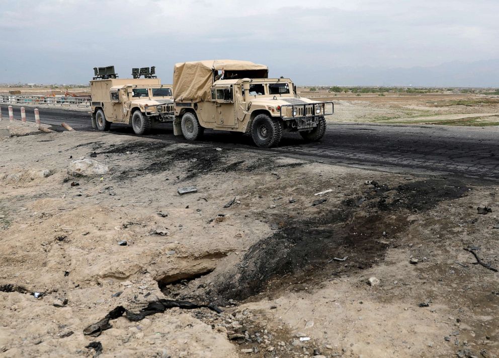 PHOTO: An Afghan military convoy drives past the site of a car bomb attack where U.S soldiers were killed near Bagram air base, Afghanistan, April 9, 2019.