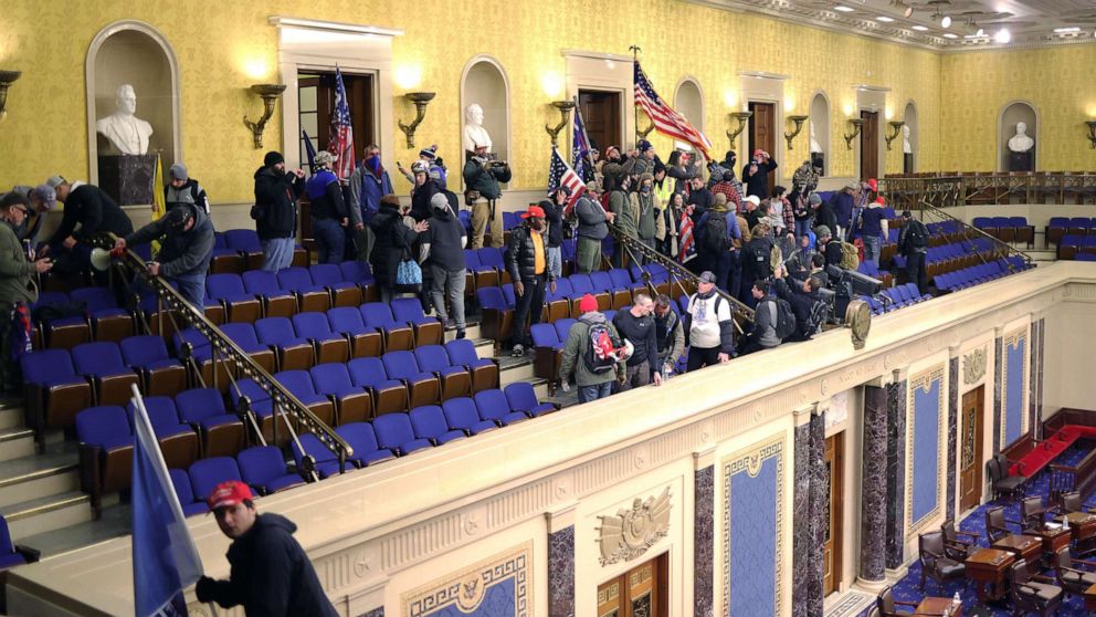 PHOTO: Protesters enter the Senate Chamber on Jan. 6, 2021 in Washington, D.C., during a joint session to ratify President-elect Joe Biden's 306-232 Electoral College win over President Donald Trump.