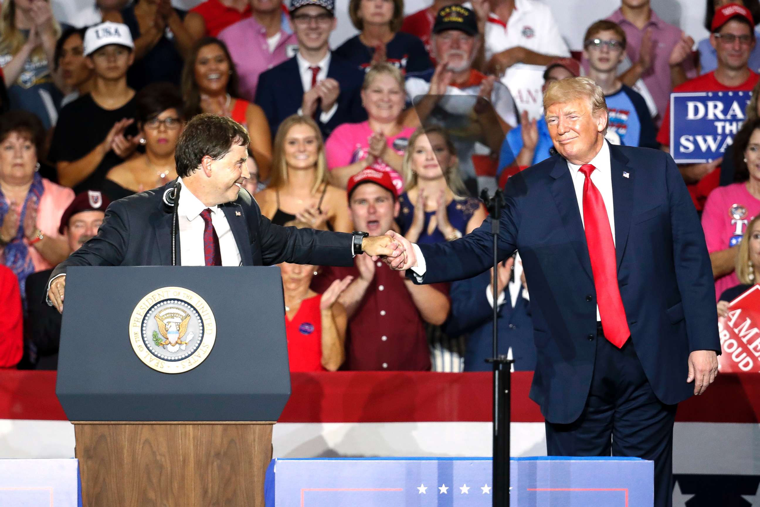 PHOTO: President Donald Trump, right, shakes hands with 12th Congressional District Republican candidate Troy Balderson, during a rally on Aug. 4, 2018, in Lewis Center, Ohio.