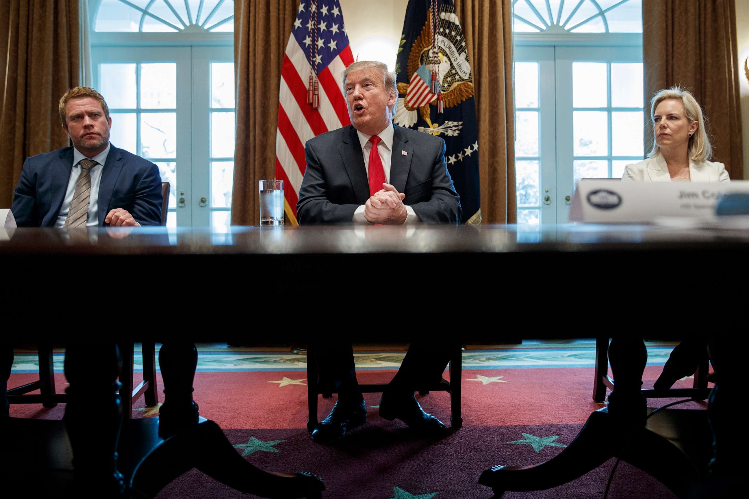 PHOTO: Timothy Ballard, CEO of Operation Underground Railroad, left, and Secretary of Homeland Security Kirstjen Nielsen, right, listen as President Donald Trump speaks during an event on human trafficking at the White House, Feb. 1, 2019.