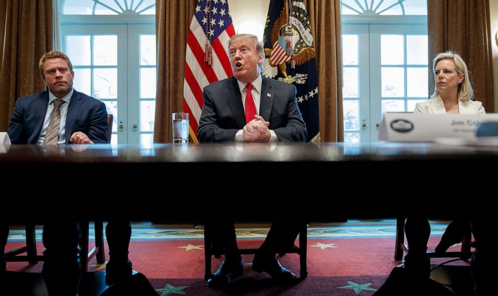 PHOTO: Timothy Ballard, CEO of Operation Underground Railroad, left, and Secretary of Homeland Security Kirstjen Nielsen, right, listen as President Donald Trump speaks during an event on human trafficking at the White House, Feb. 1, 2019.