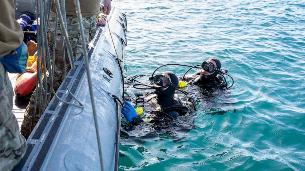 PHOTO: Sailors assigned to Explosive Ordnance Disposal Group 2 conduct pre-dive checks during recovery efforts of a high-altitude balloon in the Atlantic Ocean, Feb. 7, 2023.