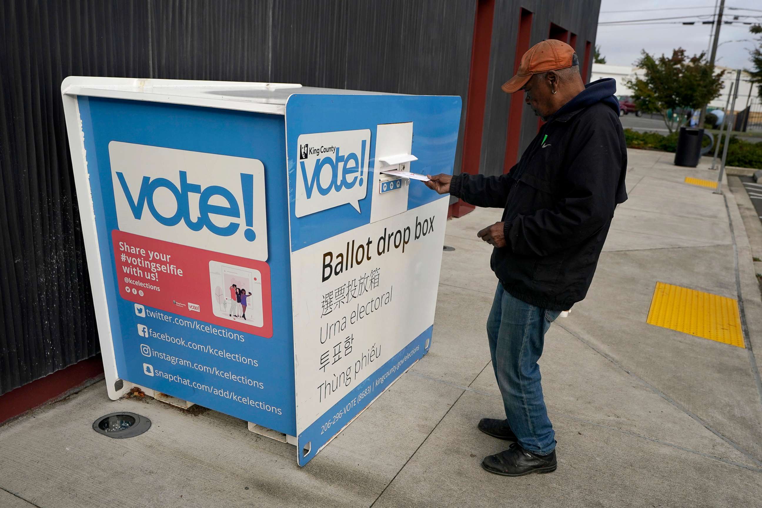 PHOTO: A man puts a ballot in a drop box, Oct. 27, 2020, at a library in Seattle's White Center neighborhood a week before election day. 