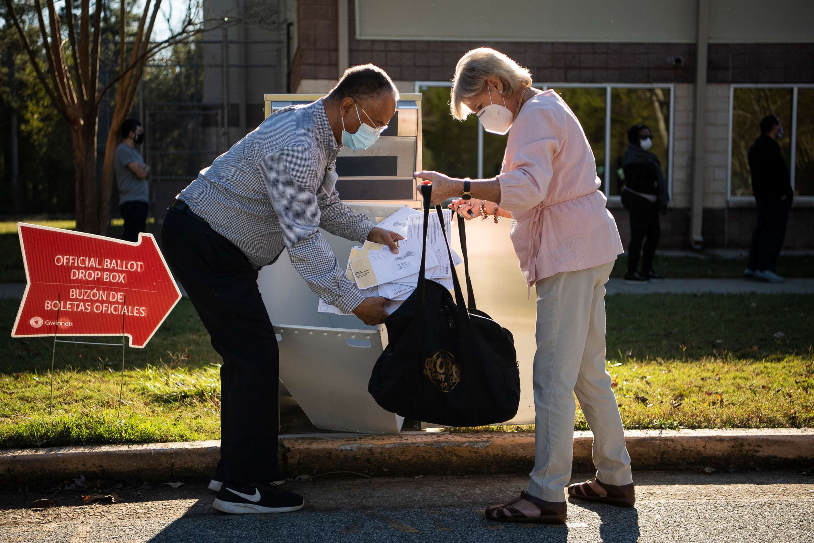 PHOTO: Election officials collect ballots from a drop box on the last day of early voting in Georgia at the Lenora Park Gym in Snellville, Ga., Oct. 30, 2020. 